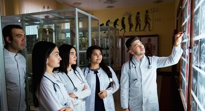 group of nursing students in a hospital room learning from an instructor