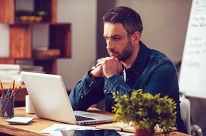 Man at a desk working on his laptop