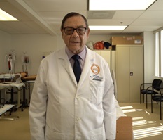 Carlos Torres standing in a hospital room