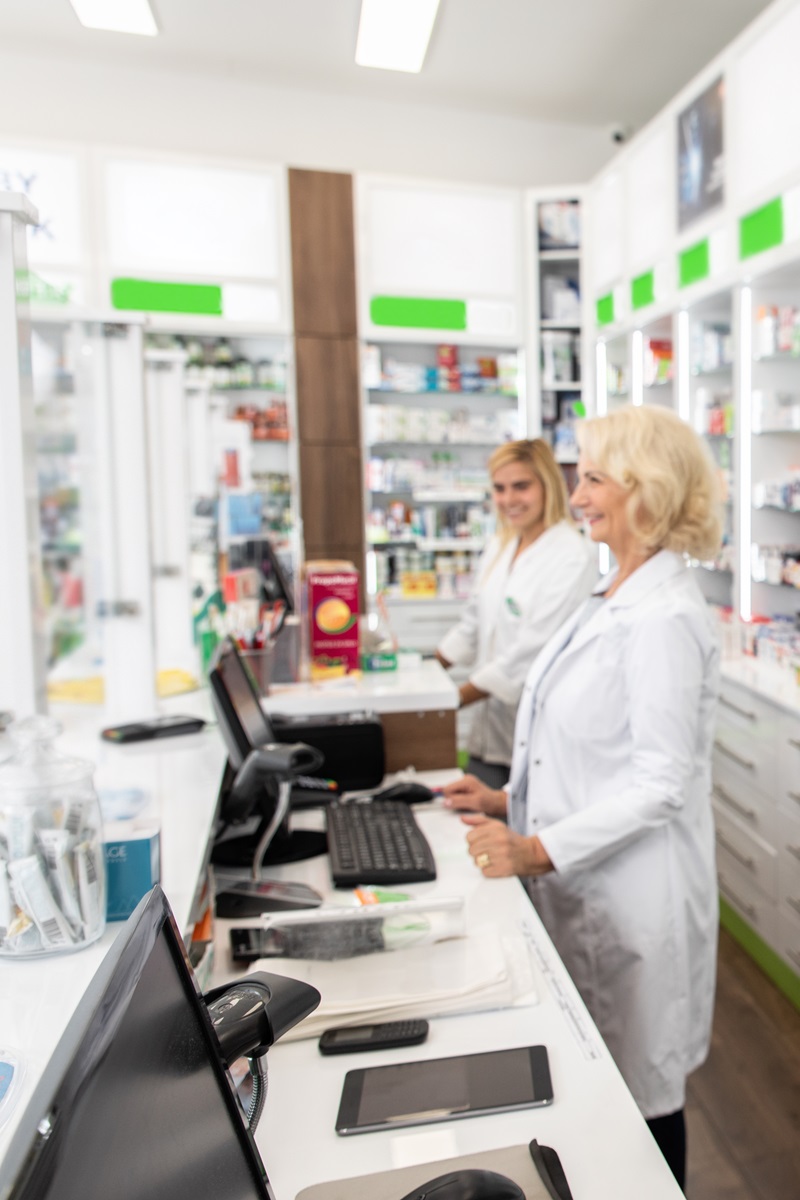 three female pharmacists standing at the pharmacy counter