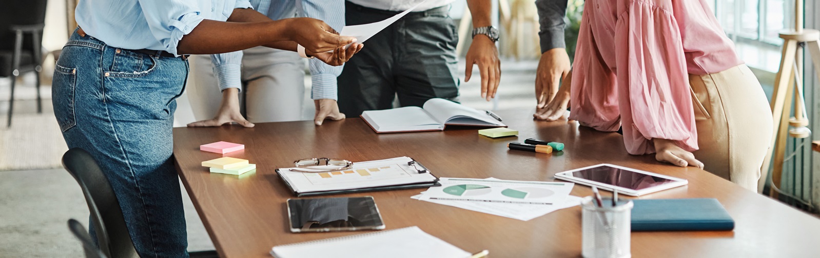 group of young professionals discussing a project around a conference table