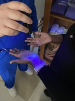 a healthcare worker doing a hand washing scan of a student