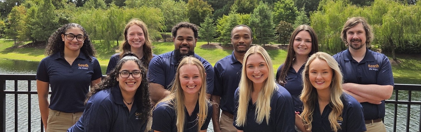 group of PTA students posing in their blue South polos outside