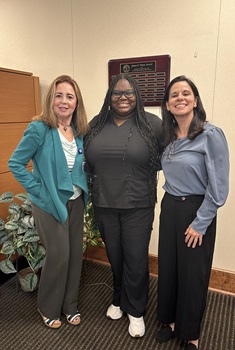 Three women from the School of Pharmacy posting together at an event