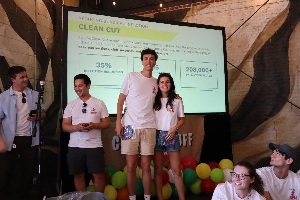 group of anesthesia science students at a presentation in white shirts and shorts