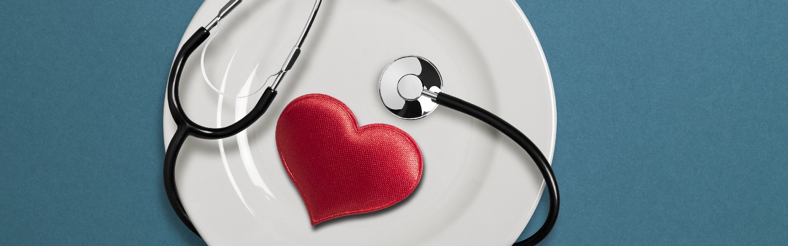 plate with a heart shaped object and stethescope on it
