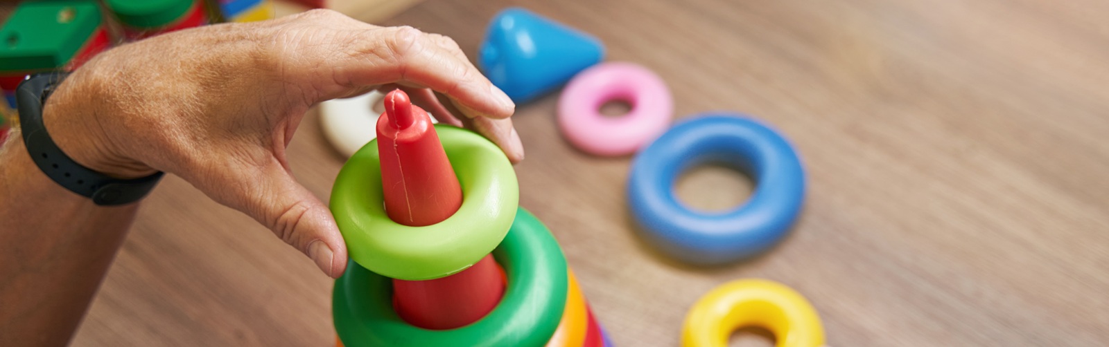 person playing with a plastic children's ring toy