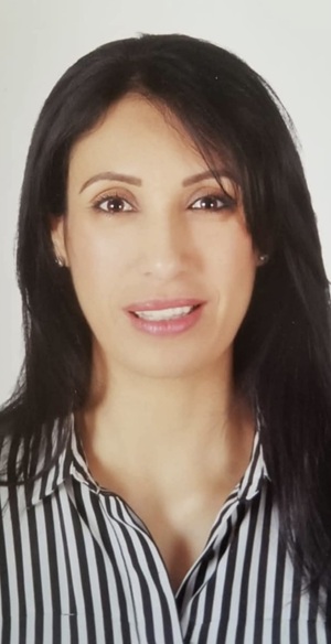 Arwa Hamed headshot in a striped shirt