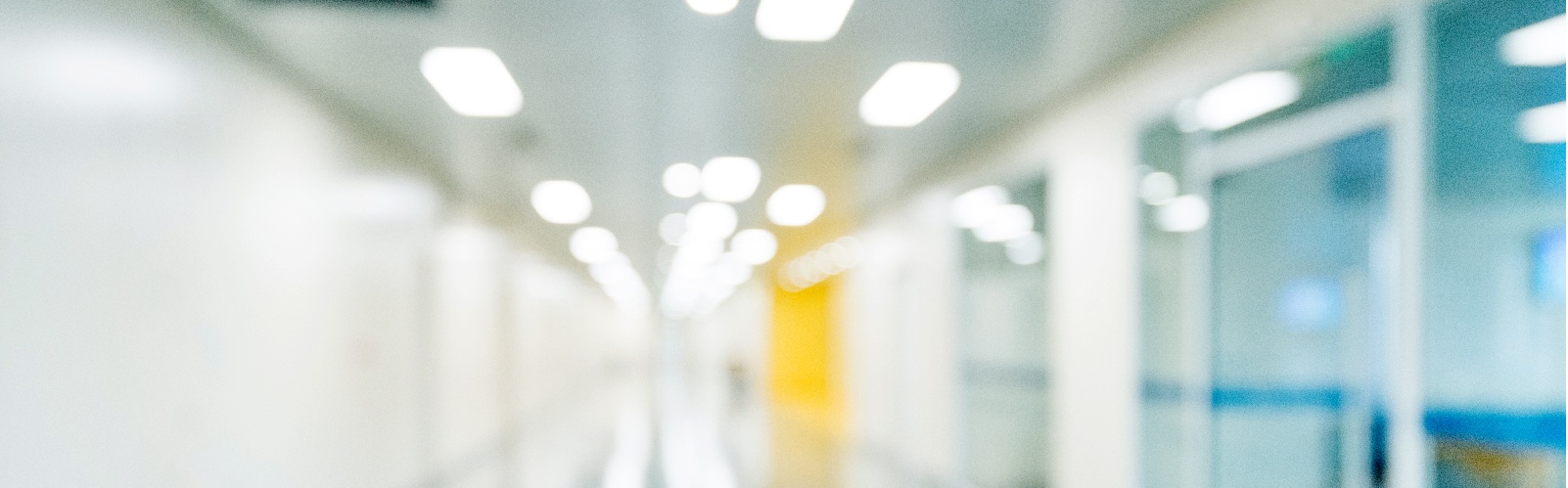hospital hallway with hospital rooms on the right side