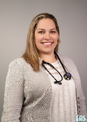 Brandi Galloway headshot wearing a sweater set and stethescope