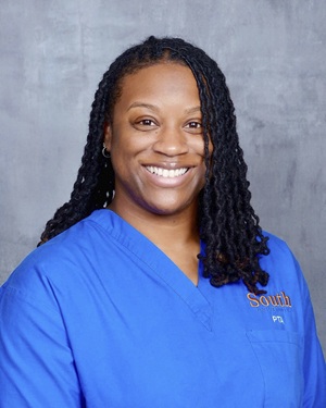 Raven Boswell headshot smiling in blue scrubs