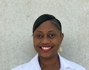 Nikisha Clouden headshot in a white shirt
