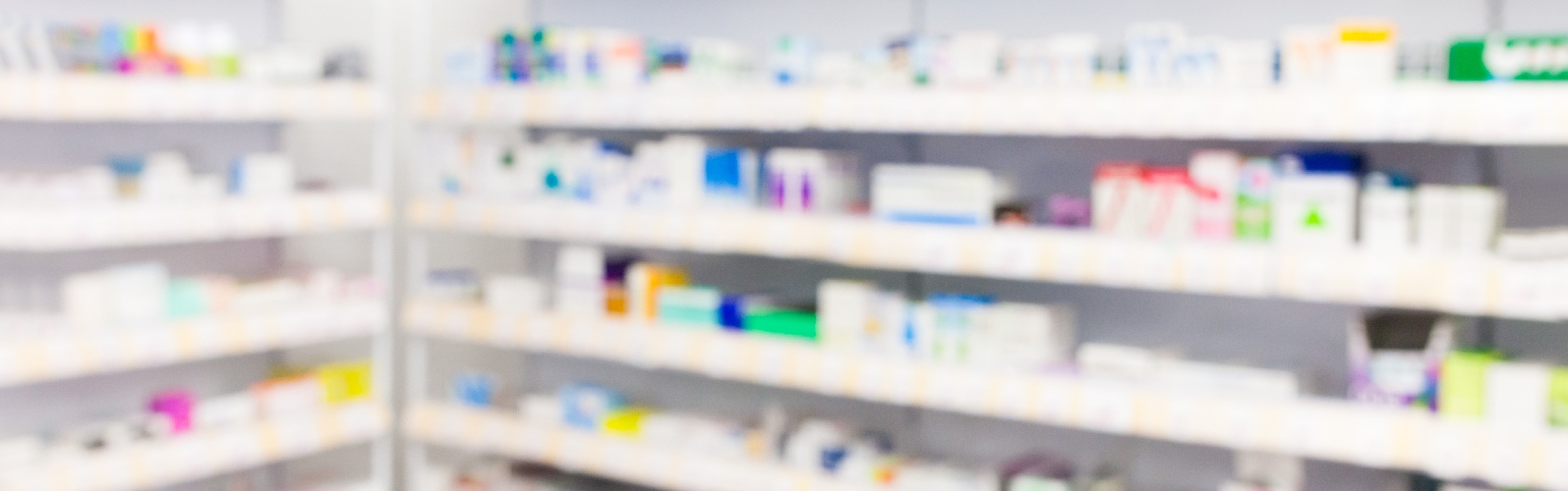 Shelves lined with pharmaceuticals in a pharmacy