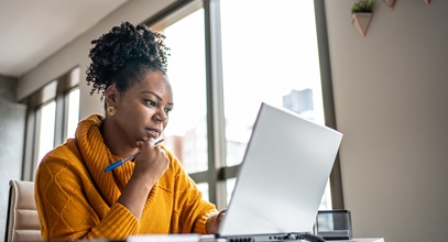 A woman working at her personal computer