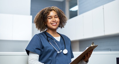 Nurse ready to assist with a clipboard in her hand
