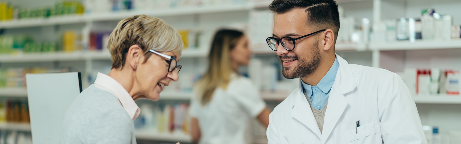 A pharmacist explains medications to a patient