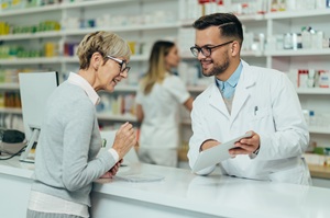 A pharmacist reviews and explains a prescription with a patient