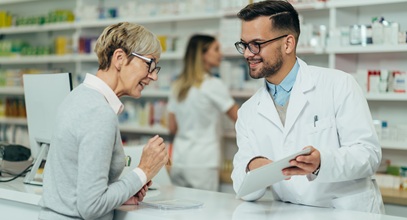 A pharmacist reviews a prescription with a patient