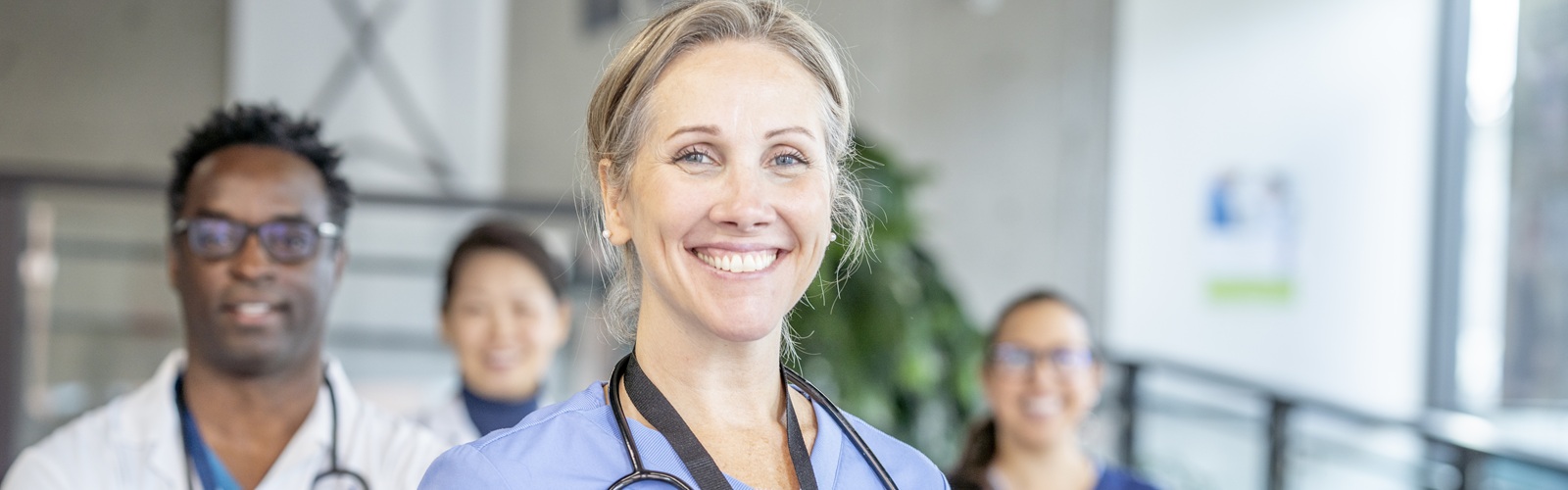 A group of nurses stands ready to go to work