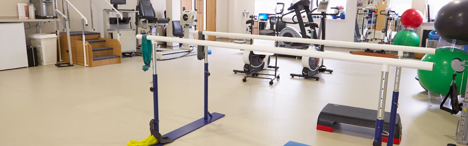 physical therapy gym equipment in a large gym room