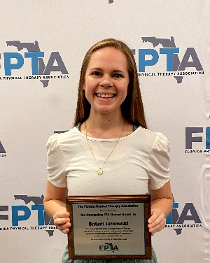 Britani Jurkowski posing with her PTA award certificate