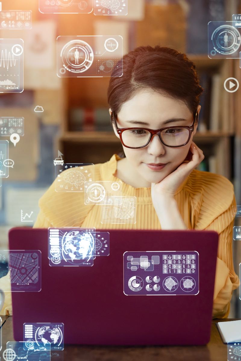 Woman in front of computer thinking of AI.