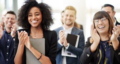 Group of young business professionals clapping