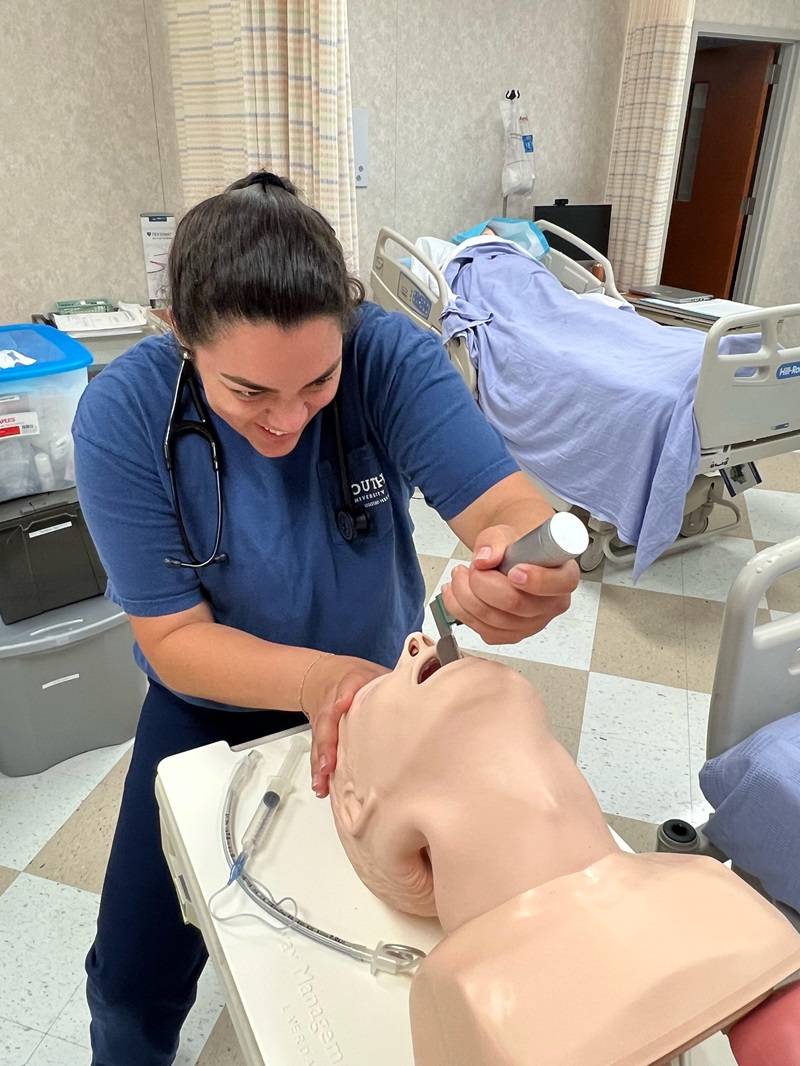 Andrea Reiter, a South University PA student, administering a procedure on a practice doll