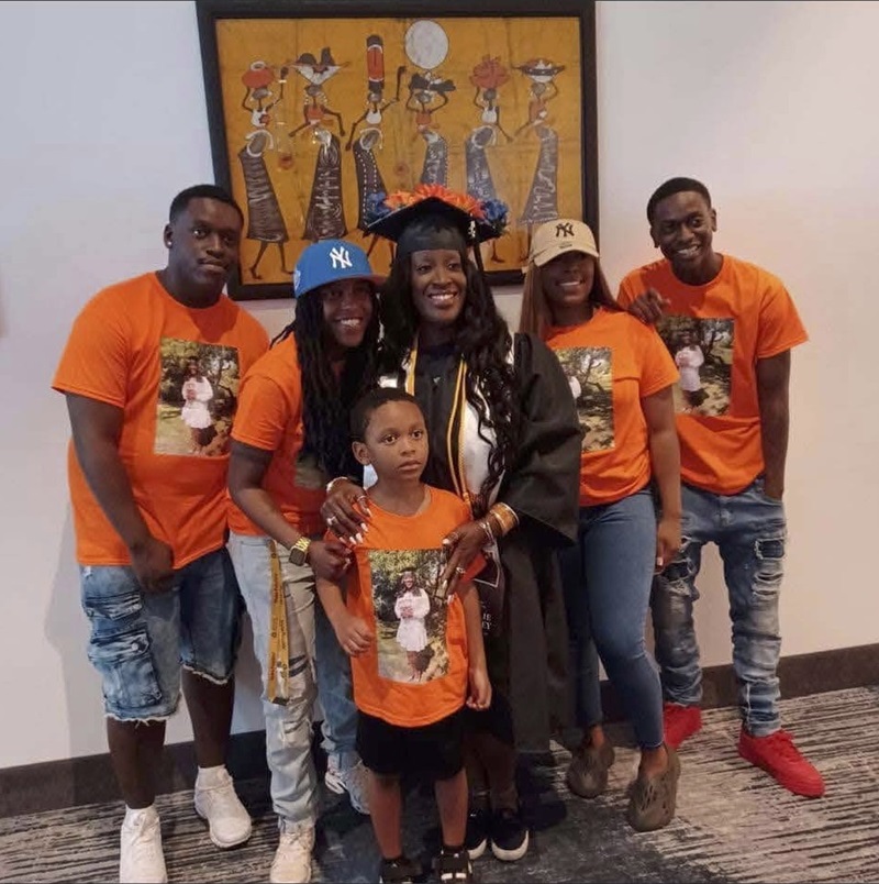 Billie Spivey in her graduation gown with her family celebrating