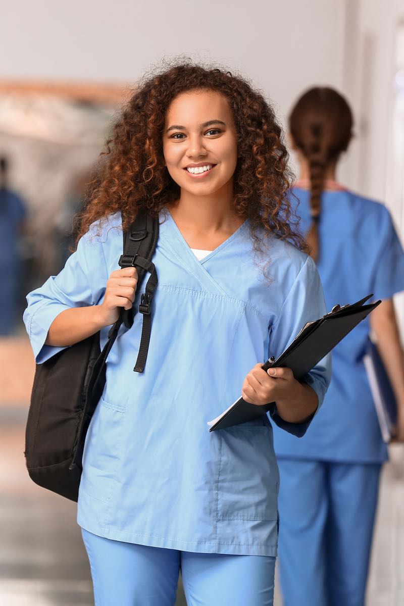 Nursing student in hallway with other students