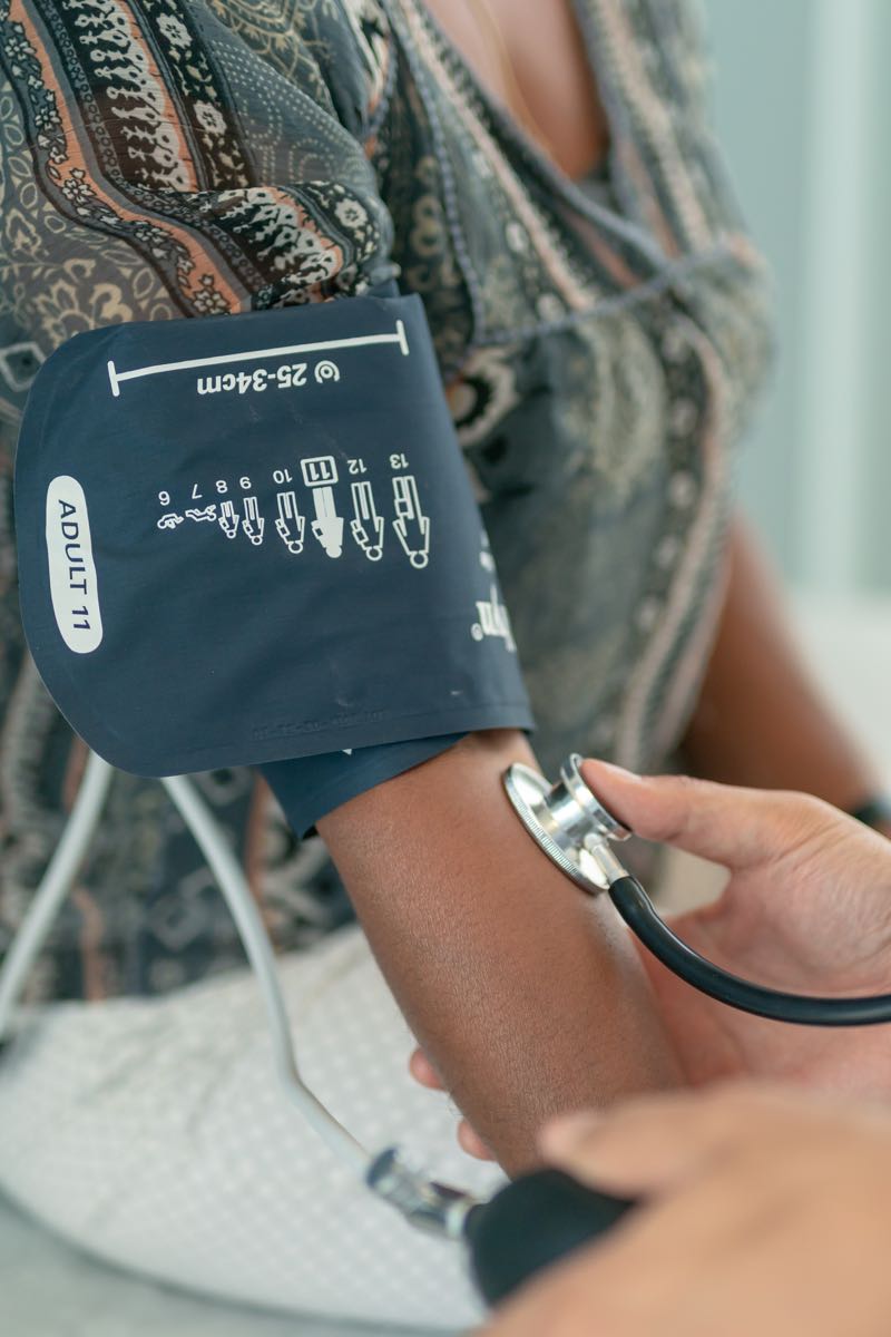 Healthcare worker taking patient's blood pressure