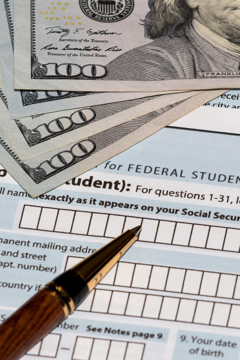 FAFSA application with pen and money