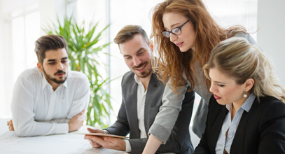 2 women and 2 men gathered around a table having a discussion