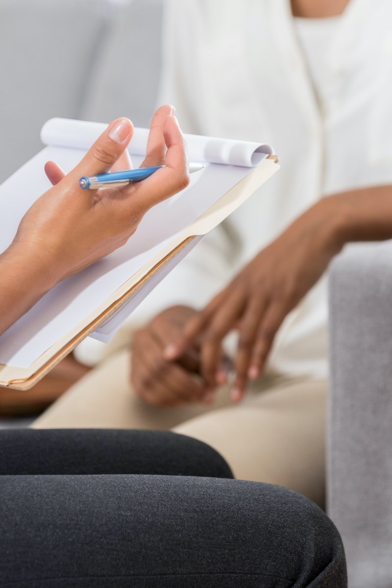 Female psychologist counseling female patient