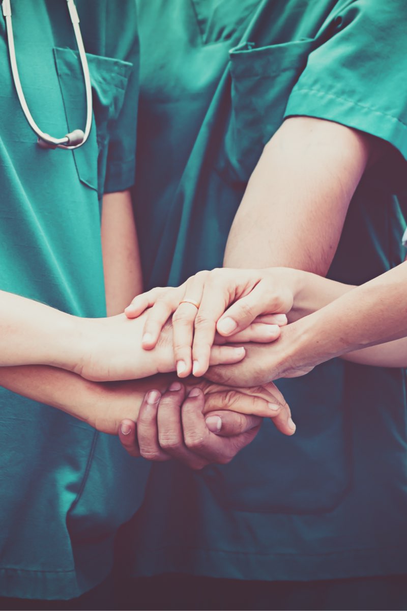 Group of nurses coordinate hands