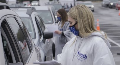South University nursing student speaking to patient in car