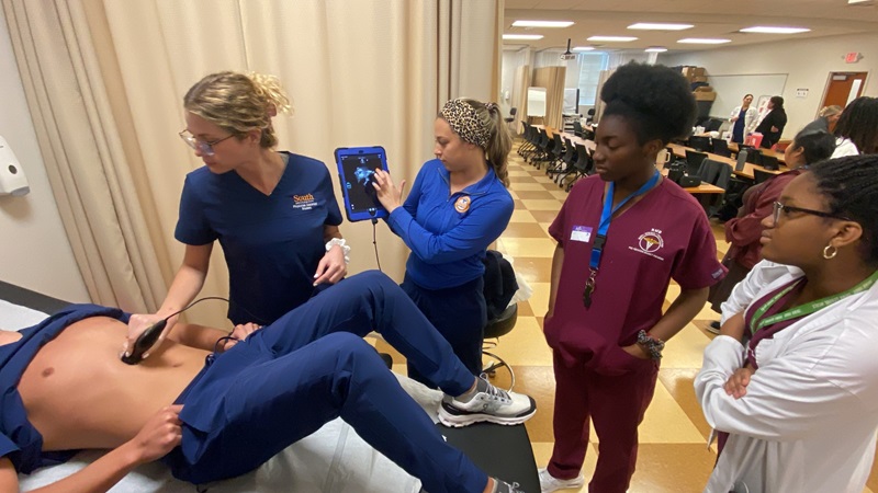 group of student nurses practicing procedures