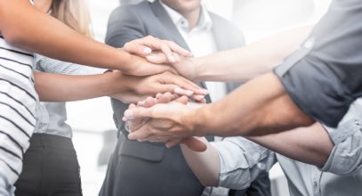 Group of people with hands stacked