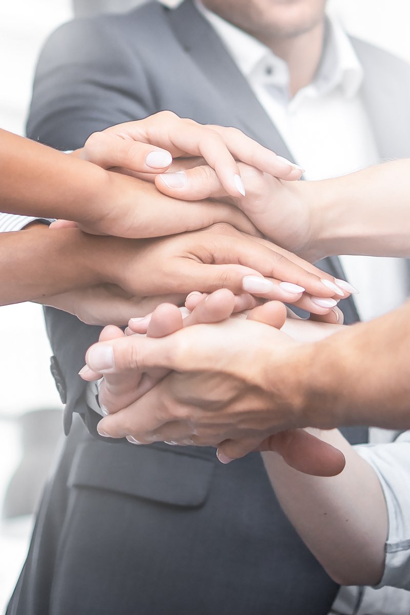 Group of people with hands stacked
