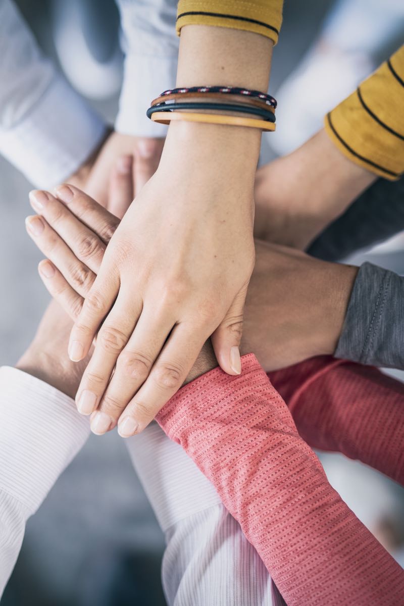 Group of business professionals with hands stacked