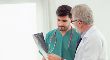 Medical practicioner discussing x-ray with doctor