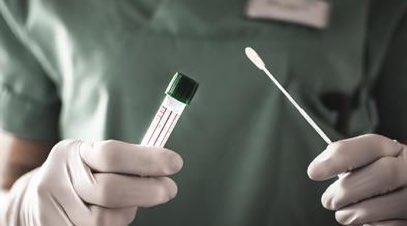 Hands holding COVID-19 test swab.