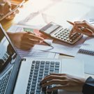 2 accountants working on computer and calculators