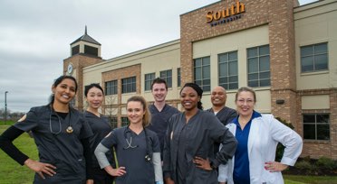 Group of South University nursing students in front of South University building