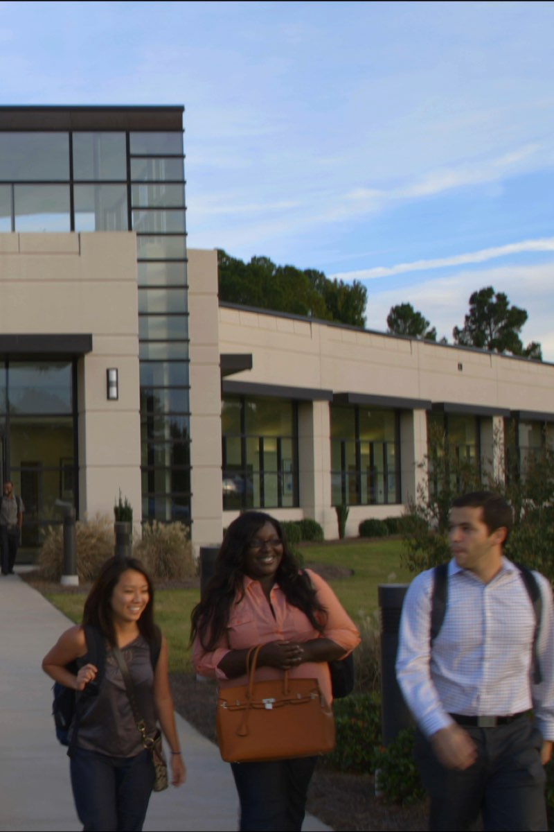 South University School of Pharmacy building with students walking in front