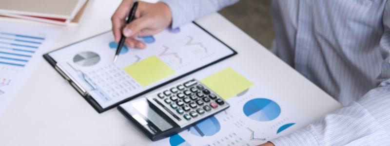 Accountant looking over graph on desk