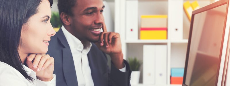 2 business professionals reviewing information on computer