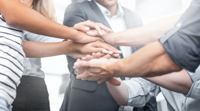 Group of people with hands on each other's hands in support