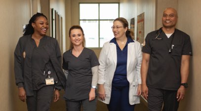 Group of South University students with instructor in hallway