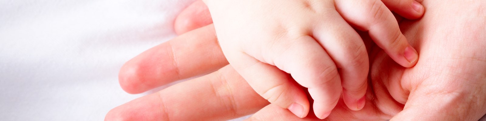 Baby's hand on adult hand